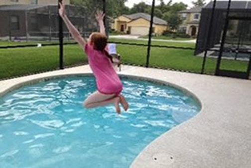 picture of girl jumping into pool at 6 Bed Home at Cypress Pointe Orlando Florida to Buy